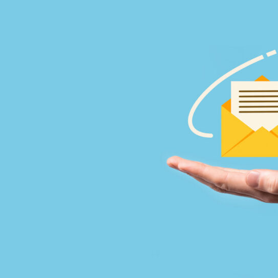 A hand holds a yellow illustrated envelope with a notification icon, as a paper airplane with a dashed trail flies above on blue background. Indicates an email marketing strategy.